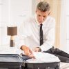 Mid-Aged Businessman Packing His Bag Stock Photo