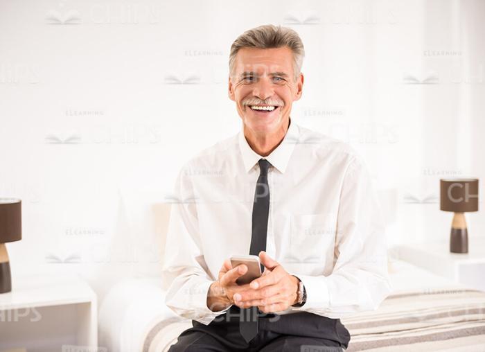 Handsome Aged Businessman At Hotel Room Stock Photo