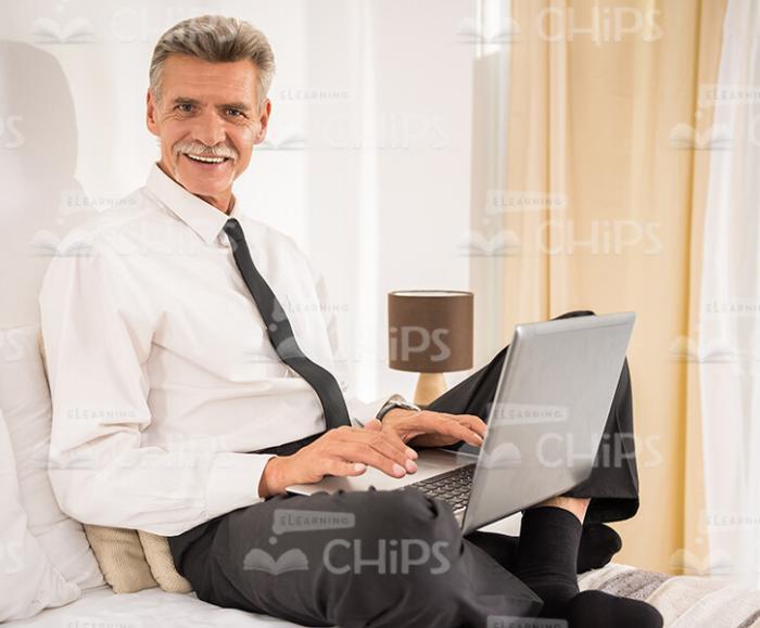 Confident Aged Business Man Working On Laptop Stock Photo