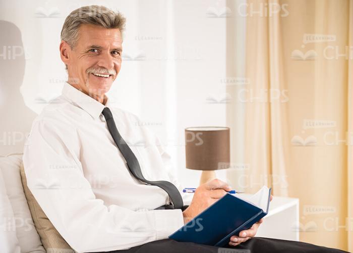 Old Businessman Working At Hotel Stock Photo
