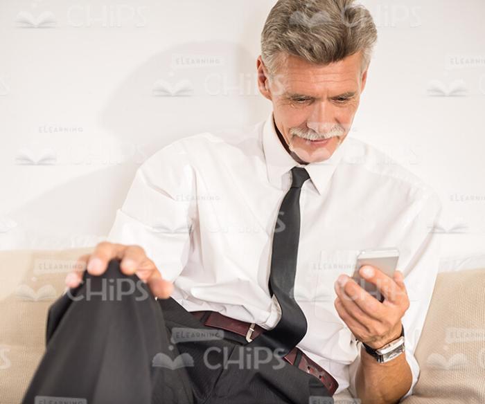 Aged Business Man Using His Smartphone Stock Photo