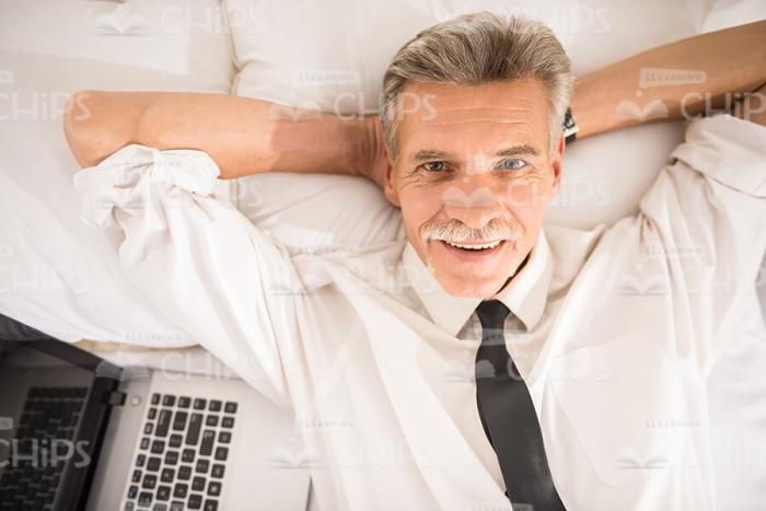 Close Up Stock Photo Of Aged Businessman Resting On Bed Stock Photo