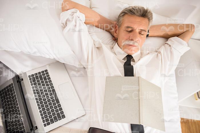 Bored Aged Businessman Sleeping Stock Photo