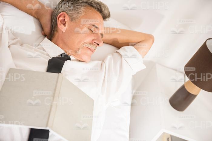 Aged Man Sleeping At Hotel Stock Photo