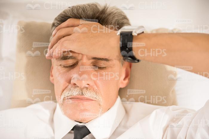 Bored Man Puts Hand On Forehead Close Up Stock Photo