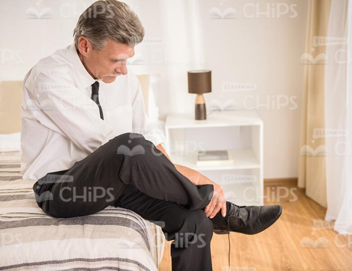 Aged Businessman Wearing Shoes Stock Photo