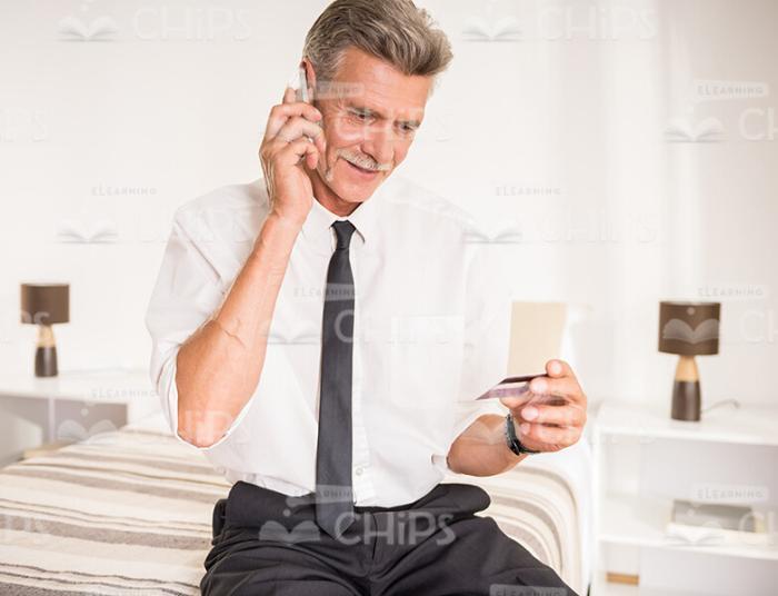 Aged Businessman Talking On Mobile Phone Stock Photo