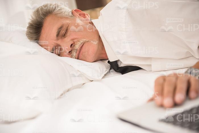 Sleeping Man's Hand On Laptop Stock Photo