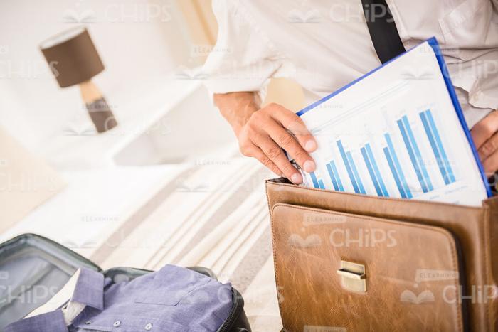 Man Packing Business Papers Into His Briefcase Stock Photo