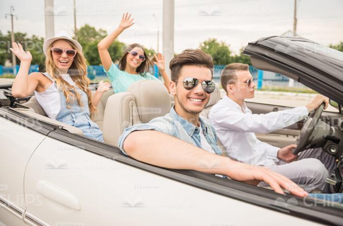 Group Of Handsome Young People Sitting In Convertible Car Stock Photo
