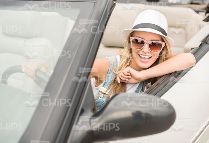 Excited Young Girl Driving Convertible Car Stock Photo