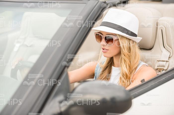 Focused Young Lady Driving Convertible Vehicle Stock Photo