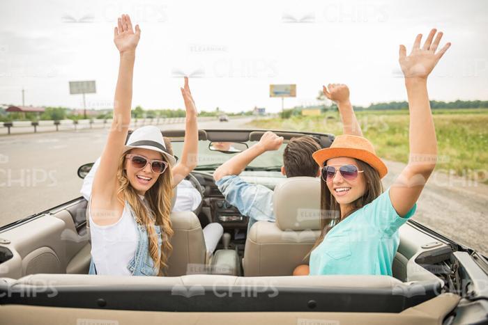 Rear View On Four Fellows Driving On Vacation In Convertible Car Stock Photo