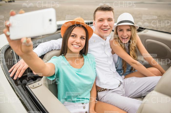 Three Young Friends Taking Selfie In Cabriolet Car Stock Photo