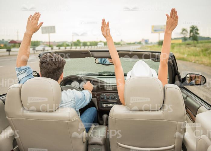 Young Couple Driving Along The Road In Cabriolet Car Stock Photo Rear View