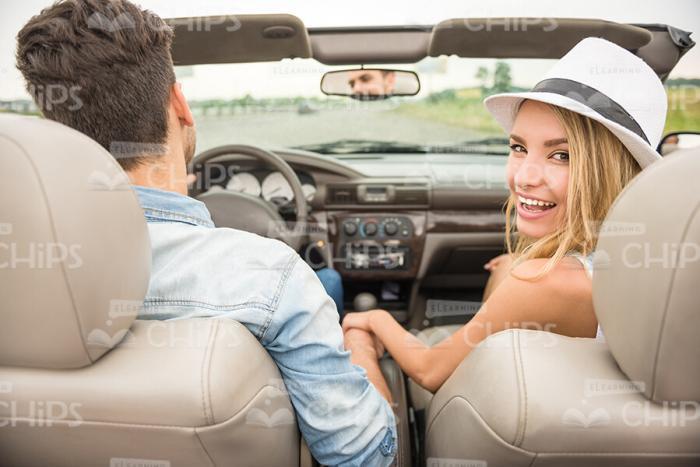 Rear View On Happy Young Couple Driving Cabriolet Stock Photo