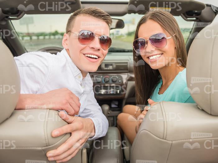 Young Couple In Cabriolet Car Wearing Sunglasses Stock Photo
