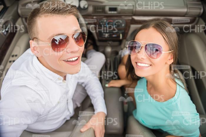 Smiling Couple In Sunglasses Sitting In Car Stock Photo