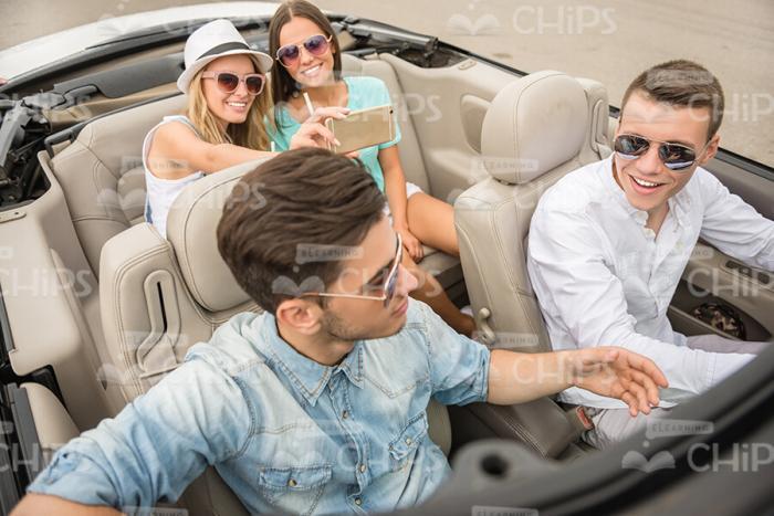 Happy Girls Make Pictures In Car Stock Photo