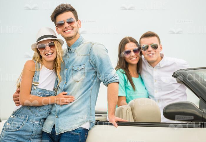 Two Couples Hugging Near The Cabriolet Car Stock Photo