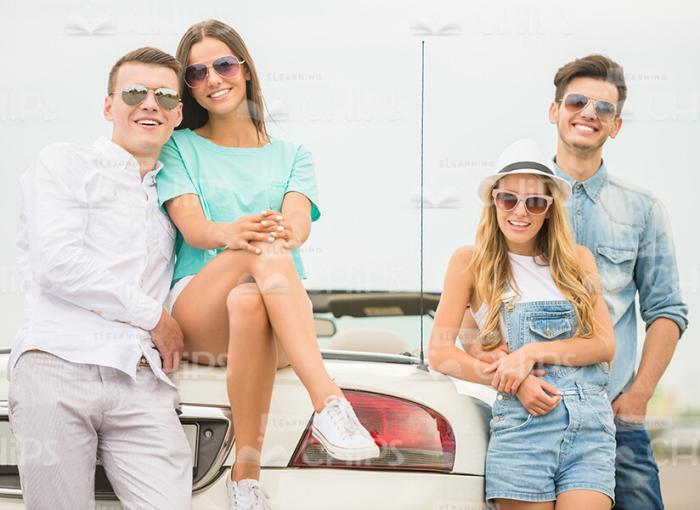 Two Nice Couples Near The Cabriolet Vehicle Stock Photo