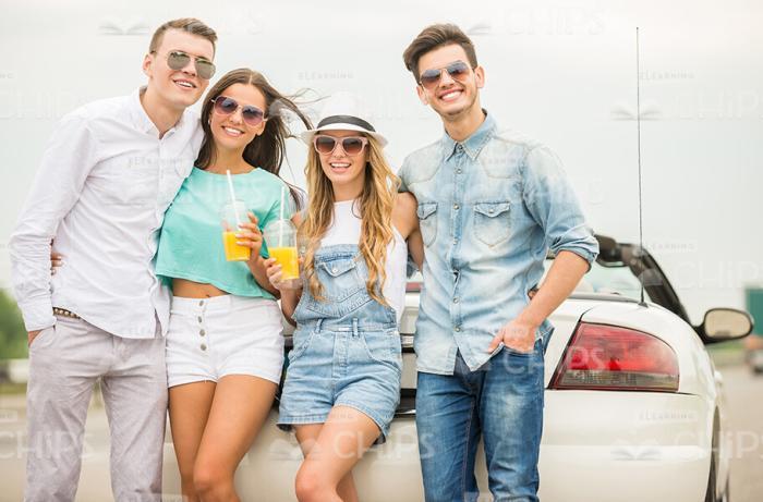 Four Handsome Friends Standing In Front Of Car Stock Photo