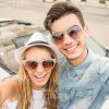 Couple Taking Selfie While Being Near Their Car Stock Photo