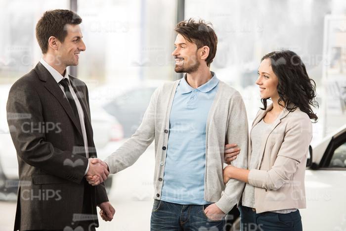Young Man Shakes Hands With Car Consultant Stock Photo