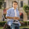 Smiling Man With Mobile Phone Leans On Bicycle Stock Photo