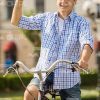 Smiling Man Riding Bicycle And Waving Hand Stock Photo