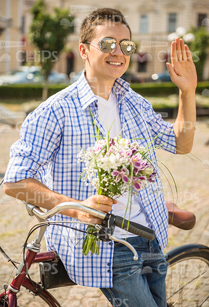 Close Up Of Handsome Young Man With Bouquet Waving Hand Stock Photo
