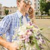 Smiling Man Holding Bouquet Of Flowers And Talking On Mobile Phone Stock Photo