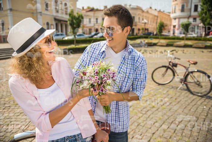 Man Giving Flowers To Girlfriend Stock Photo
