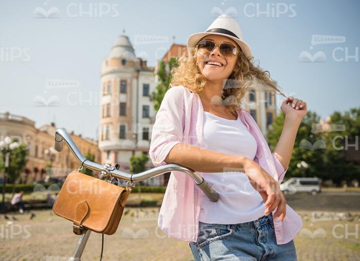 Nice Woman Leaning On Bike Stock Photo