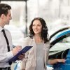 Vehicle Salesman Consults Female Buyer Stock Photo