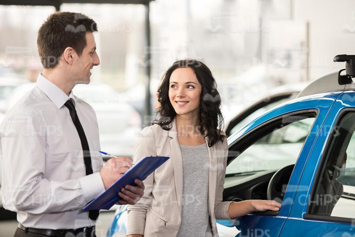 Vehicle Salesman Consults Female Buyer Stock Photo