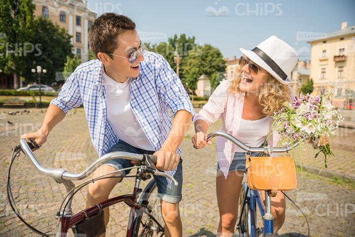 Nice Couple Joking While Riding On Bikes Together Stock Photo
