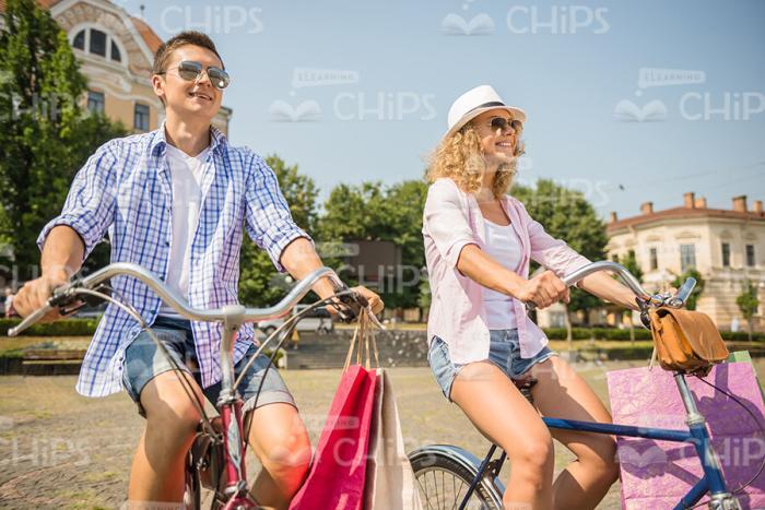 Smiling Young People Riding On Bikes Stock Photo