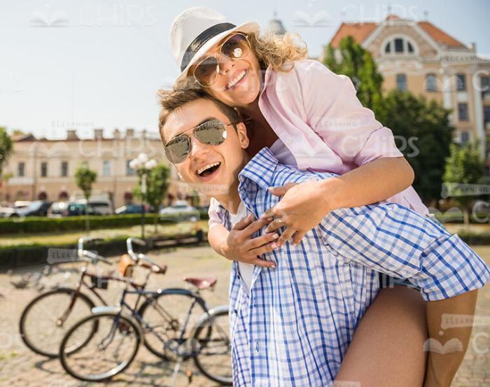 Young Woman Hugging Her Friend From The Back Stock Photo