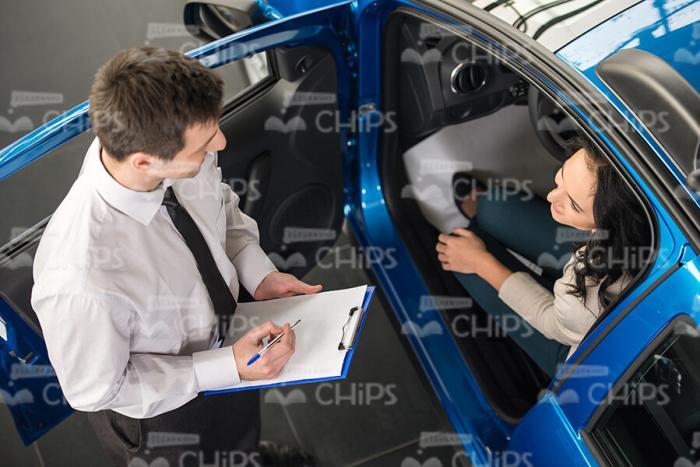 Young Woman Sitting In Car At Dealershop Stock Photo
