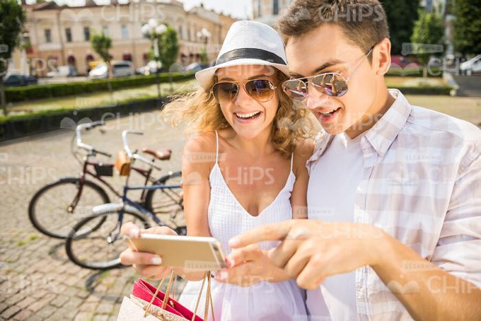 Surprised Couple Looking AT Mobile Phone's Screen Stock Photo