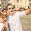 Cheerful Young Couple Taking Selfie On City Square After Shopping Stock Photo