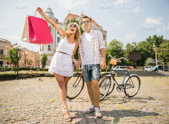Happy Young Couple With Shopping Bags Stock Photo