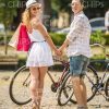 Pretty Couple Holding Hands And Turning To Camera Stock Photo
