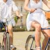 Couple Cycling Through The City Stock Photo
