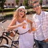 Excited Couple With Bicycles Drinking Juice Stock Photo