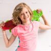 Pretty Young Girl Holding Skateboard Behind Her Head Stock Photo