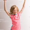 Happy Girl Raising Up Her Skateboard Stock Photo