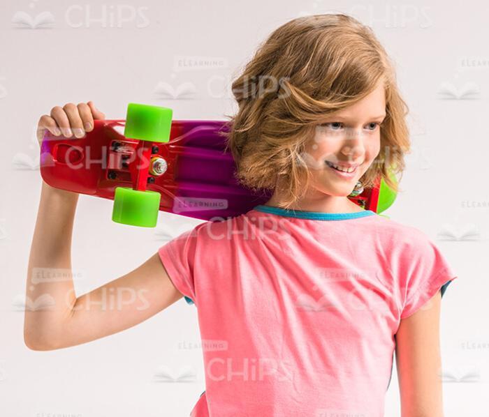 Confident Young Girl With Skateboard Stock Photo