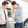 Car Salesman Talking To Client Stock Photo